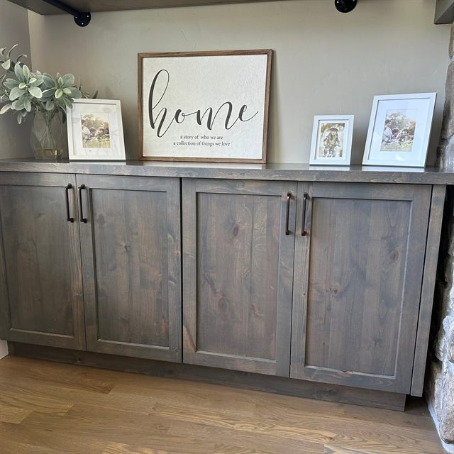 Grey-stained shaker built-in buffet cabinet run along a living room wall
