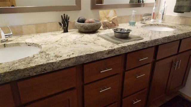 Double bathroom vanity with a granite countertop, two undermount basins and shaker drawer fronts